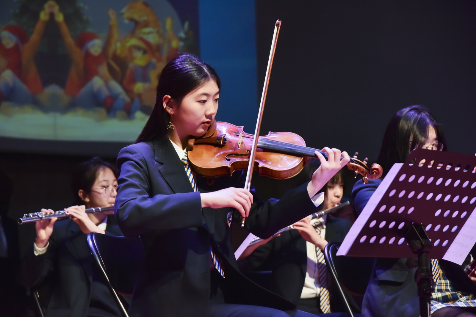 Leading the school orchestra as concertmaster